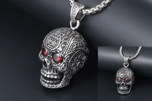 Detailed view of punk silver skull pendant with red gemstone eyes and box chain