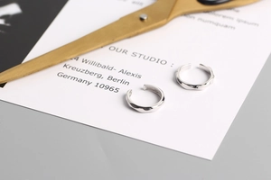 Detail shot of silver S925 sterling silver ear cuffs with twisted faceted design