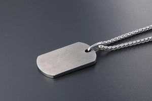 Detailed close-up of a silver brushed titanium steel military tag necklace for men