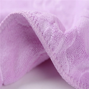 Detailed macro view of purple microfiber towel showing soft texture and reinforced edging