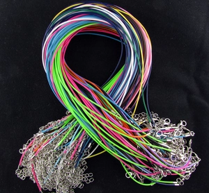 Close-up of assorted colored wax cord necklaces with silver lobster clasps and chains