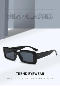 Detail view of retro black rectangular sunglasses with stylish metal dot accents