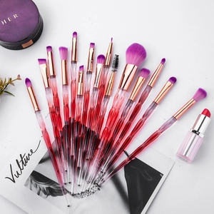 Macro detail of 15-piece makeup brush set with diamond textured handles and purple bristles