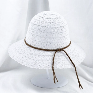 Detail of white lace sun hat featuring breathable hollow crochet and brown braided cord