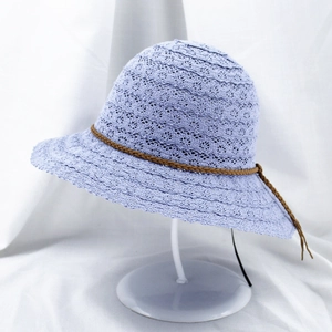 Close-up of lavender lace crochet straw hat featuring a brown braided drawstring detail