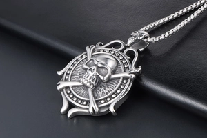 Macro shot of silver vintage skull and crossbones steering wheel pendant on black leather