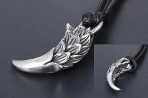Macro view showing the intricate scales and claw details of the vintage steel pendant