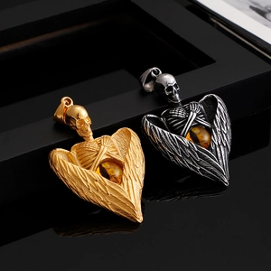 Gothic skull angel wing pendants in gold and silver steel with amber eye accents