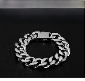 Detailed close-up of a silver men's Cuban chain bracelet on premium black leather