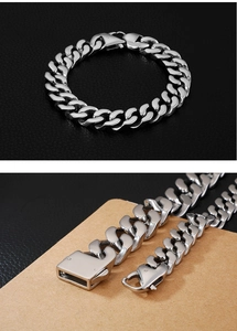 Detailed close-up of silver titanium steel Cuban link bracelet with high-polish finish
