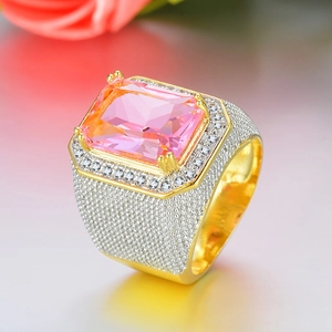 Macro detail of luxury men's hip hop ring with pink rectangular zircon and gold plating