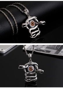 Detailed macro view of punk snake necklace with realistic demon eye pendant and twist chain