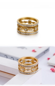 Macro detail of multi-layer gold star ring with cubic zirconia and starburst motif