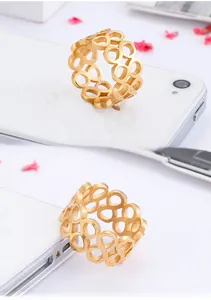 Close-up of golden hollow geometric ring showing intricate stacked circular design details