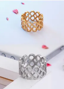Detailed view of infinity loop patterns on gold and silver stainless steel rings