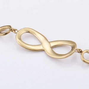 Polished gold infinity symbol bracelet featuring elegant stainless steel chain links