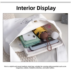Interior view of white canvas tote bag showing large capacity for iPad and umbrella