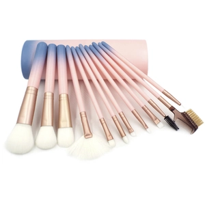 Detail of 12-piece makeup brush set with pink-blue gradient handles and storage cylinder