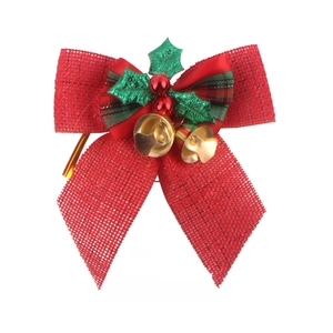 Detailed red burlap Christmas bow with green plaid accents, holly leaves and gold bells