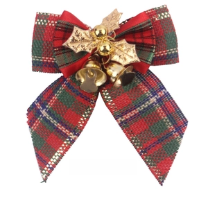 Detail of plaid Christmas bow with golden bell and metallic leaves decoration