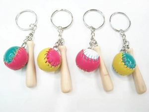 Detail view of mini baseball bat and leather ball keychains in four colorful combinations