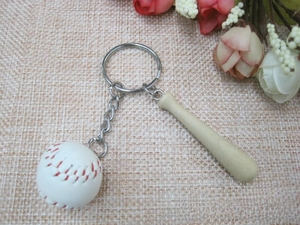Detail of mini baseball bat keychain with authentic stitching and natural wood texture