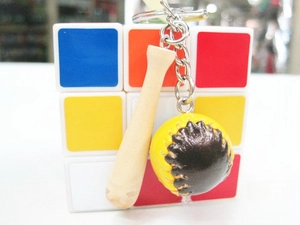 Detailed macro view of wooden baseball bat and stitched ball keychain pendant