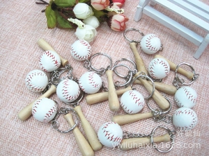 Detailed view of mini wooden baseball bat and ball keychains for sports souvenirs