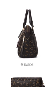 Detail view of brown tote bag showing side zipper and protective bottom metal feet