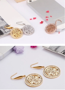 Detail of Hamsa hand earrings in gold silver and rose gold with pavé crystals