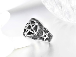 Macro view of vintage star titanium steel ring with black embossed texture and silver finish