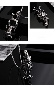 Detailed macro view of an owl skeleton pendant made of aged stainless steel and punk chain