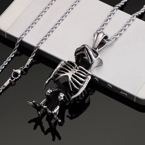 Polished silver owl skeleton pendant with twisted chain over a black reflective background