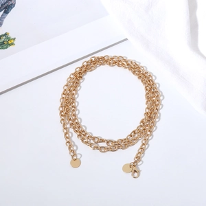 Detail of multi-layered gold metal waist chain with round sequins and lobster clasp