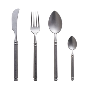 Retro silver stainless steel cutlery set with steak knife, fork, and spoons on white background