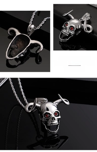 Detailed views of punk bull horn skull pendant with red stones on a steel chain