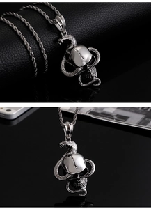 Detailed view of silver punk snake and skull pendant with intricate metal textures