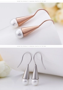 Detailed view of rose gold and silver conical earrings with elegant white pearls