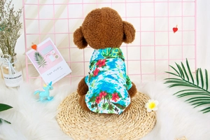 Detail of pet Hawaiian shirt with palm tree and red flower prints on a teddy dog model