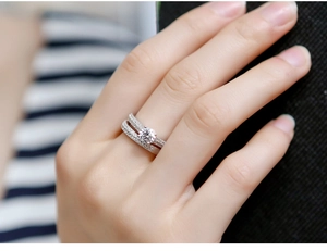 Close-up of a silver pavé wedding ring set with sparkling diamonds on a hand