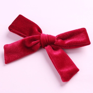 Macro shot of 5-inch handmade velvet bow hair clip showing soft fabric texture