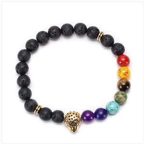 Close-up of lava rock bead bracelet with a golden leopard head and colorful chakra stones