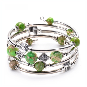 Detailed macro view of multi-layer bracelet with green imperial jasper beads and silver tubes
