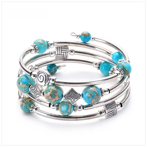 Detail of bohemian multilayer bracelet with blue imperial stone and vintage silver beads