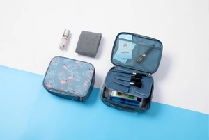 Detail view of open flamingo cosmetic bag showing waterproof inner storage and capacity