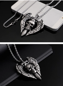 Detailed view of punk skeleton skull pendant with wings and sword on a steel chain