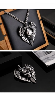 Detailed view of Gothic silver skull pendant with wings and sword on rope chain