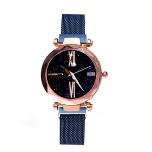 Macro detail of starry blue watch dial with roman numerals and magnetic mesh band