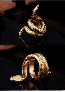 Macro shot of gold cobra wrap ring showing detailed snake scales and vintage punk style
