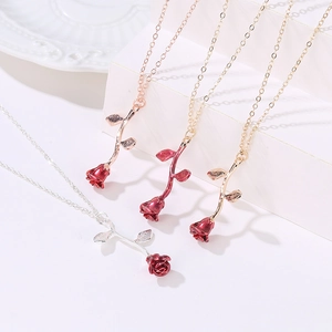 Elegant enamel red rose pendant necklaces in gold and silver finishes on display